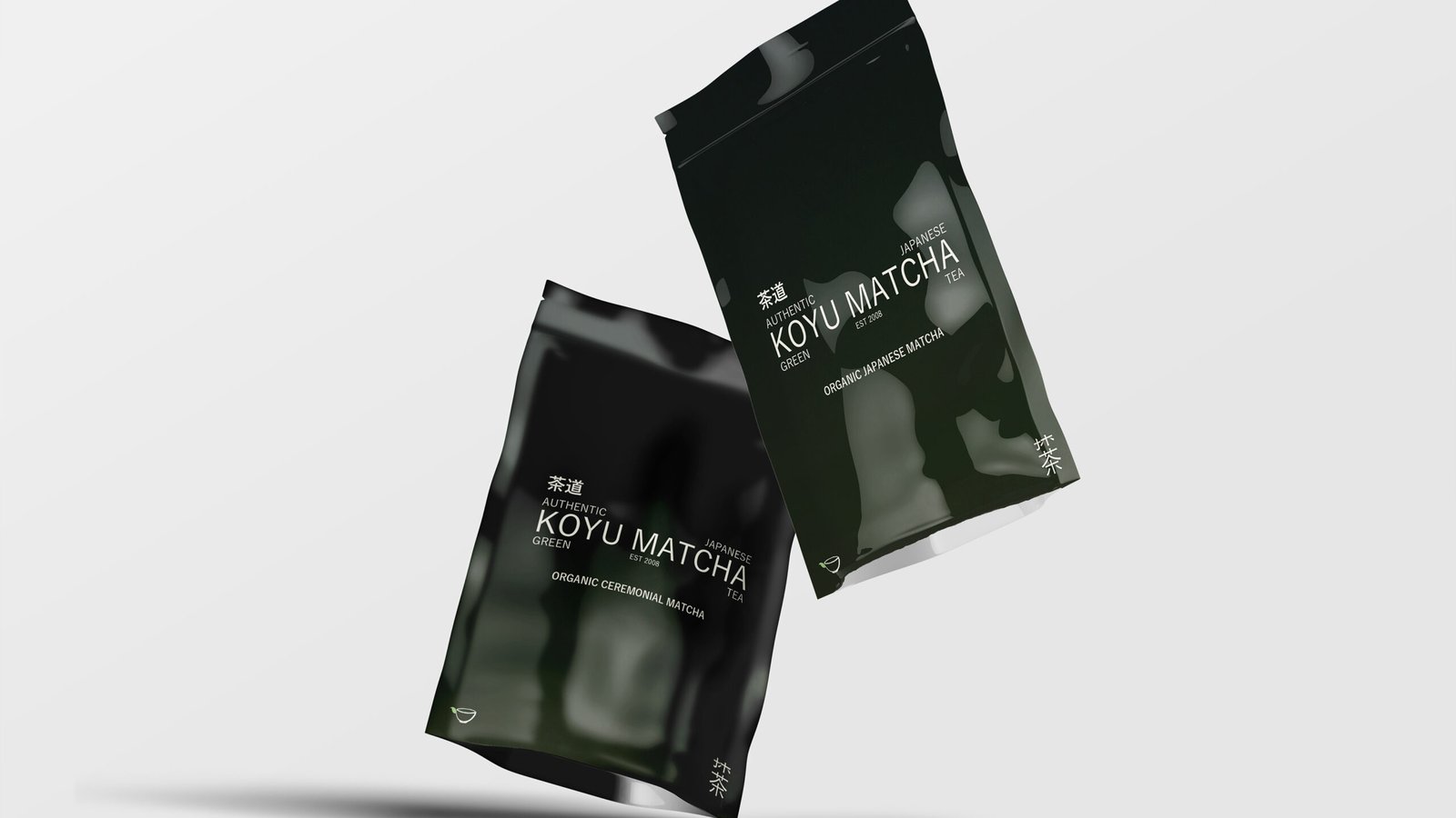 Two black Koyu Matcha pouches photographed floating against a pale grey background